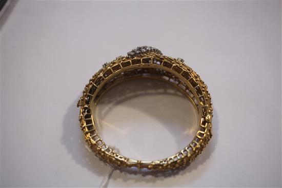 An 18ct yellow gold and diamond hinged bangle, of rod and sphere design, gross weight 59.3 grams.